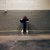 A person sitting alone in a corner, evoking themes of solitude and emotion.